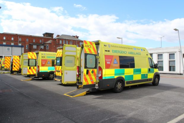 Three ambulances in a hospital forecourt